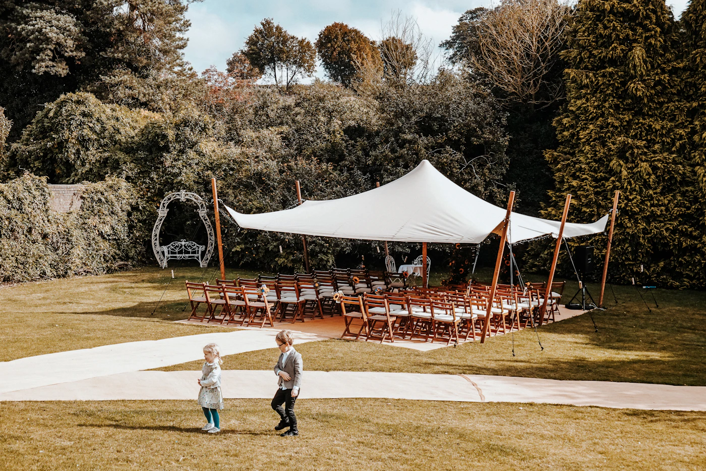 Rain plan templates for outdoor tented receptions — A clear-top tent protects an outdoor reception while keeping sky views intact.