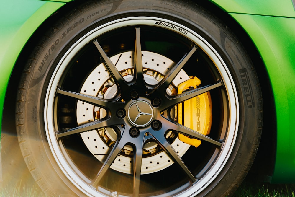 a close up of a tire on a green sports car
