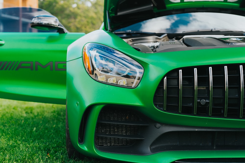 a close up of the hood of a green sports car