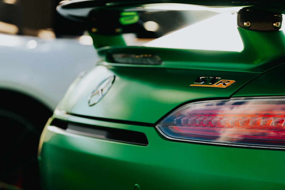 a close up of the tail lights of a green car