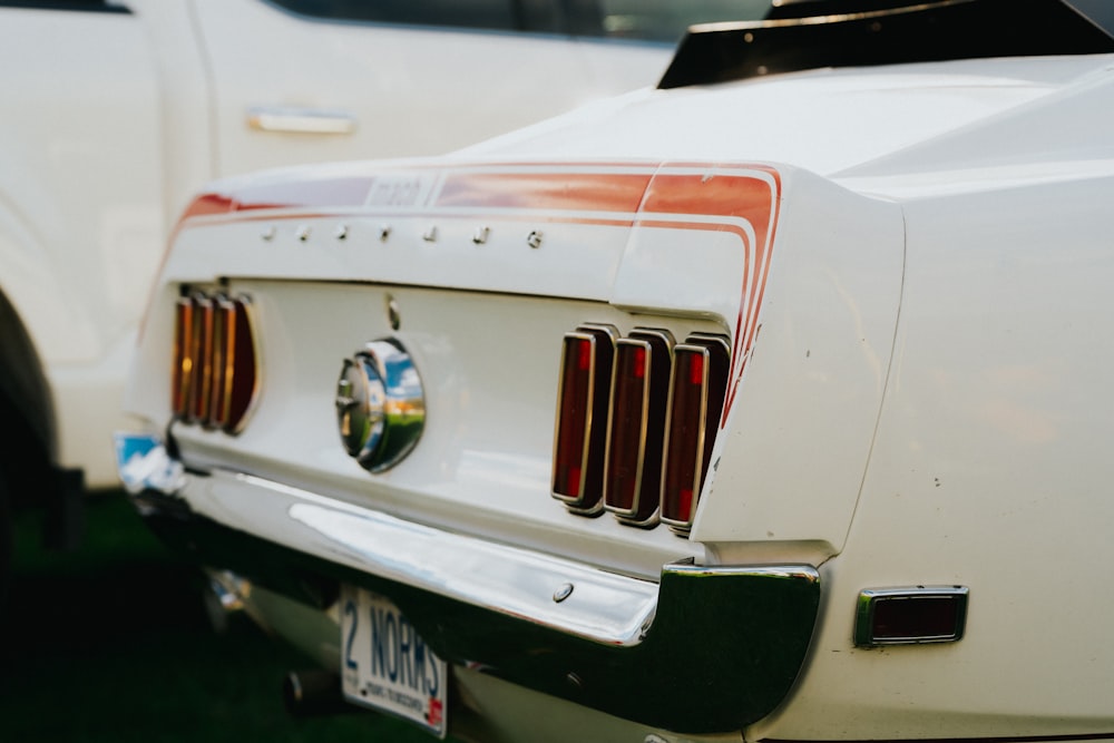 a close up of the front of a white mustang