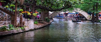 a canal with a bridge over it and people walking on it