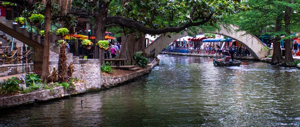 a canal with a bridge over it and people walking on it