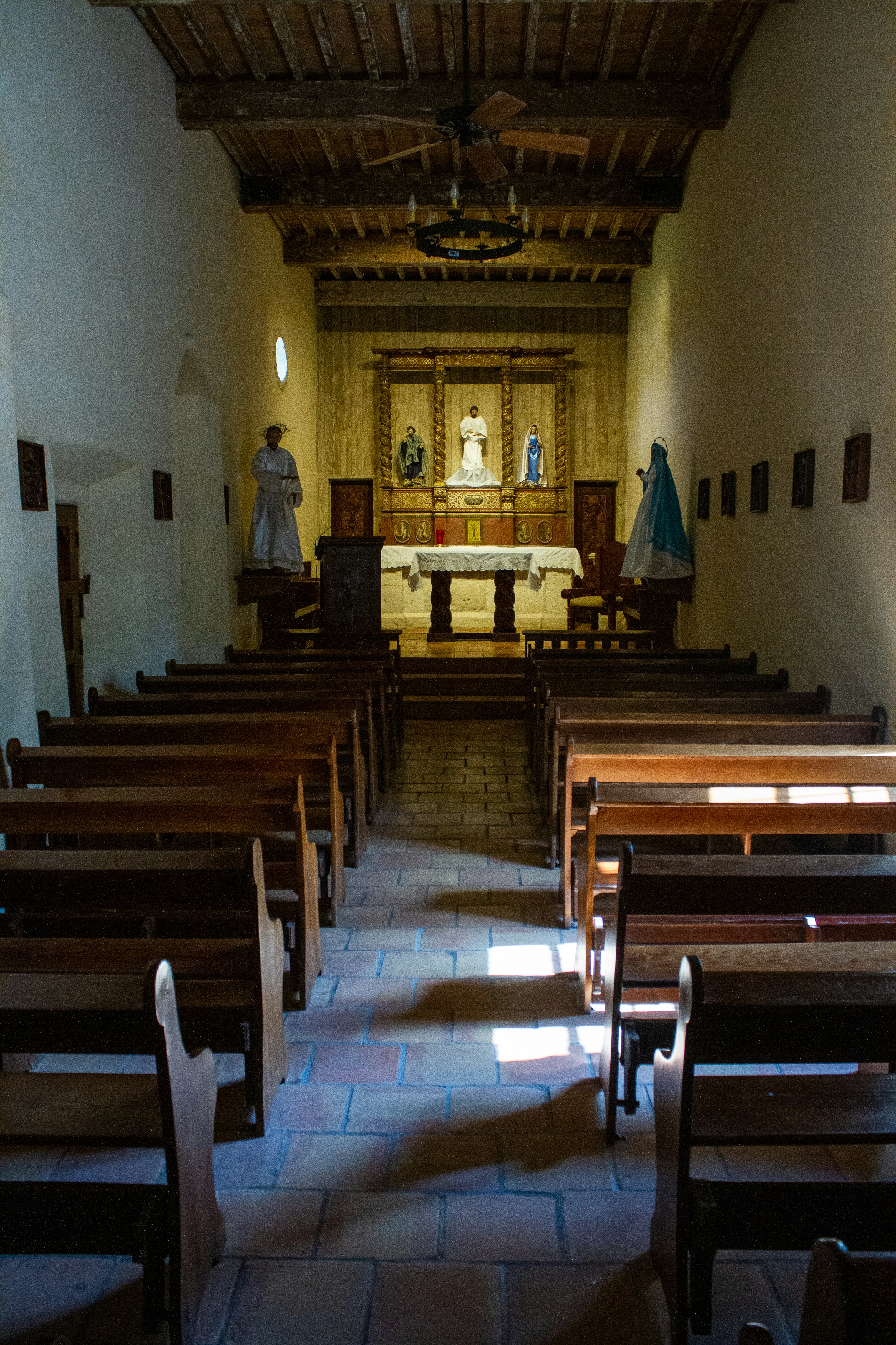 the inside of a church with pews and a statue