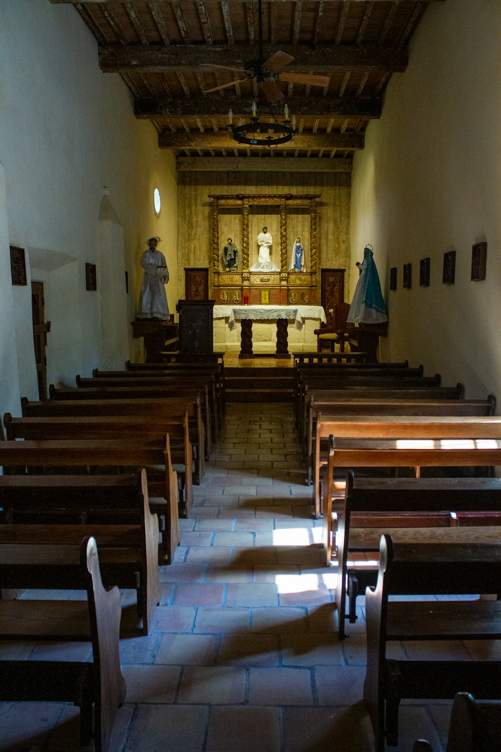 the inside of a church with pews and a statue