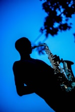 A vertical image of a saxophonist performing.