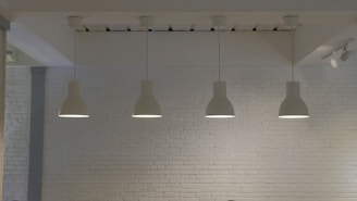 a room with a brick wall and four lights