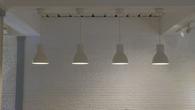 a room with a brick wall and four lights