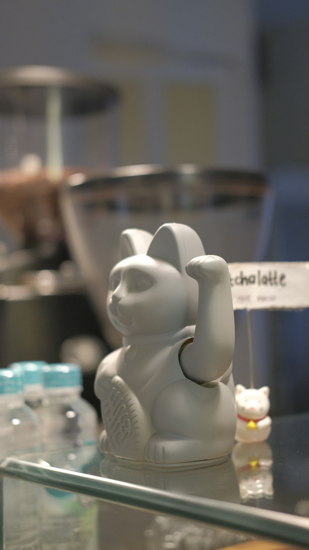 a white bear figurine sitting on top of a glass table