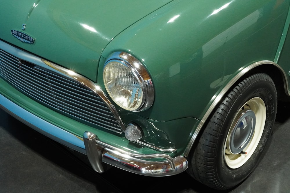 a close up of the front end of a green car