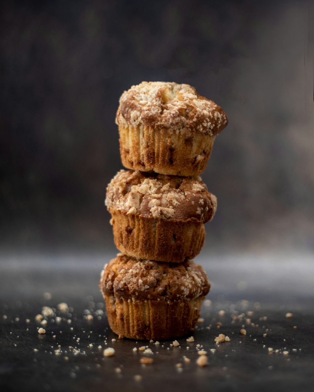 a stack of three muffins sitting on top of a table
