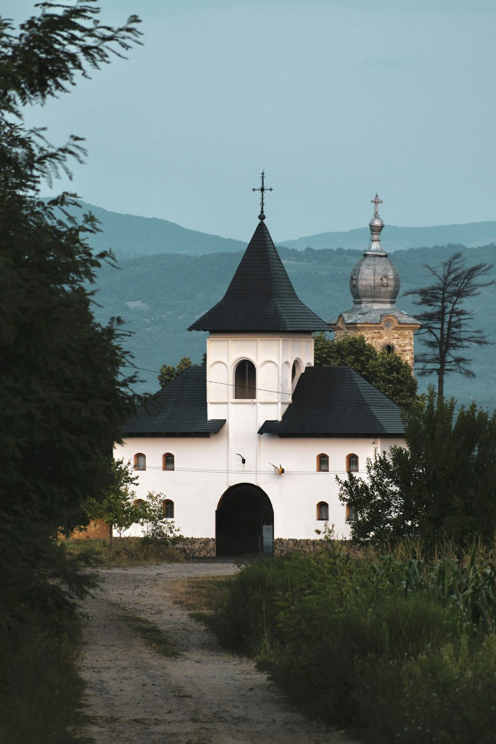 a large white building with a black roof