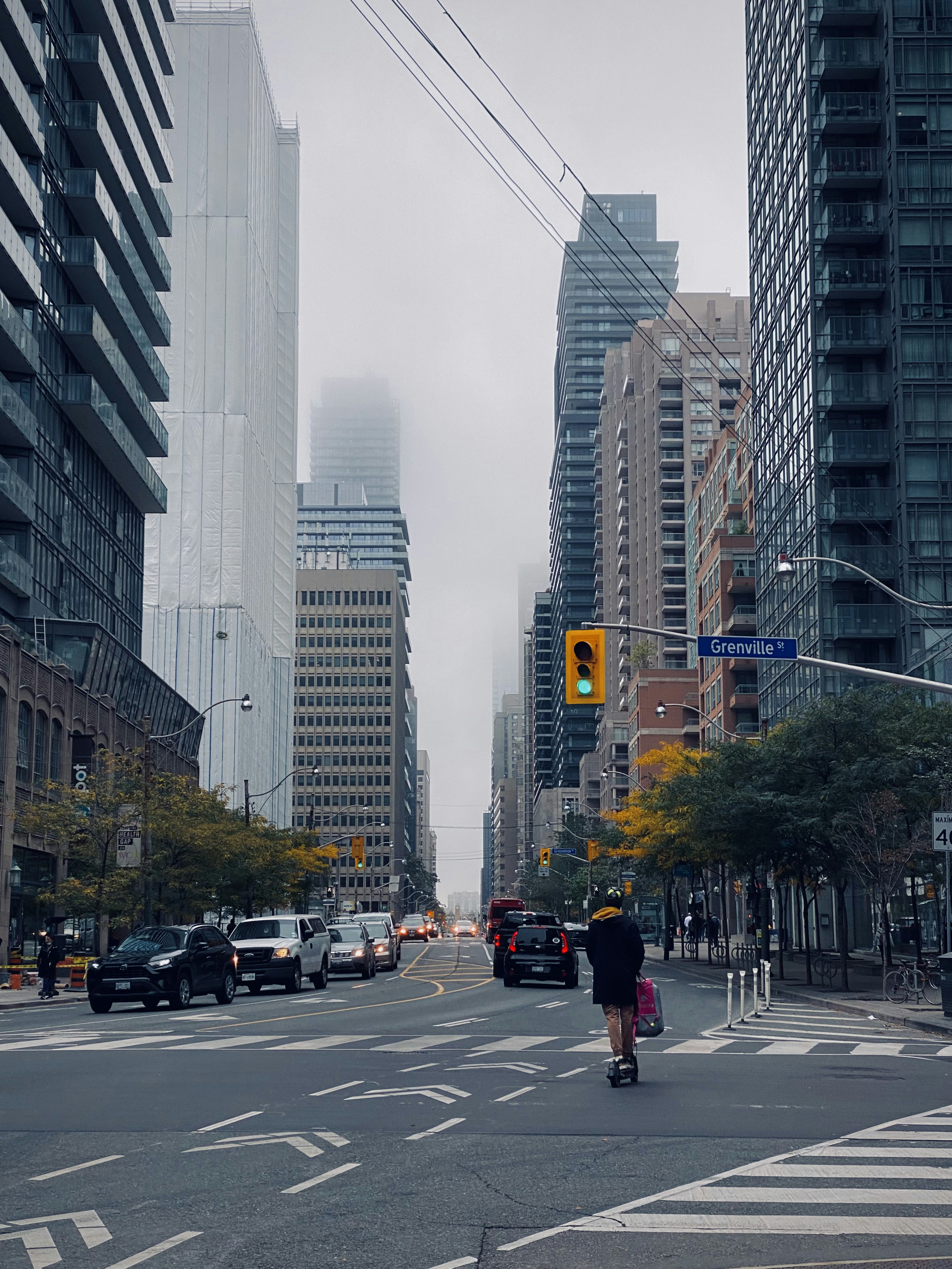 a person riding a scooter down a city street