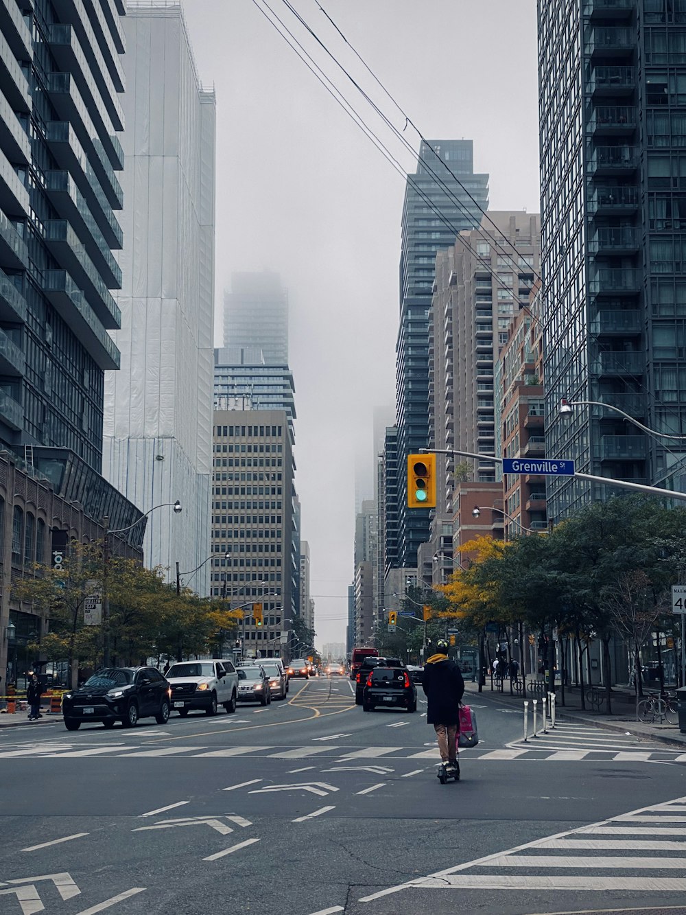 a person riding a scooter down a city street