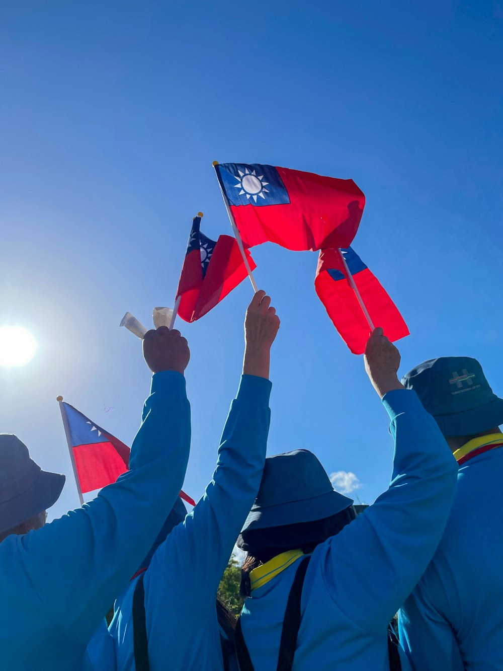 a group of people holding up red and blue flags