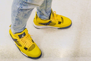 Yellow runners worn with jeans