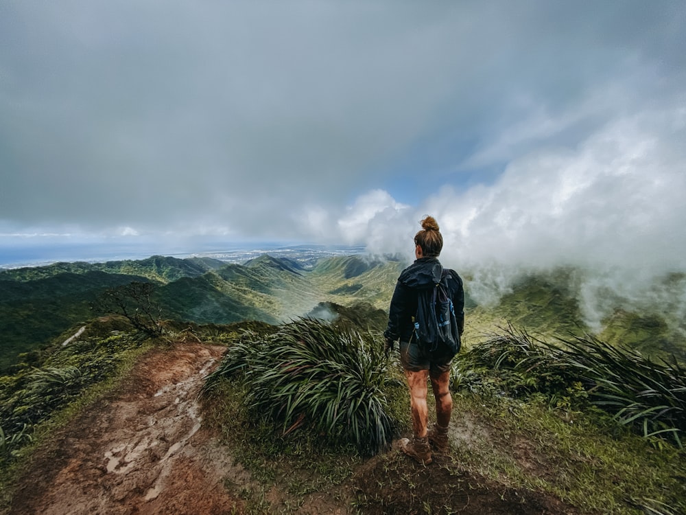 a person with a backpack walking up a hill