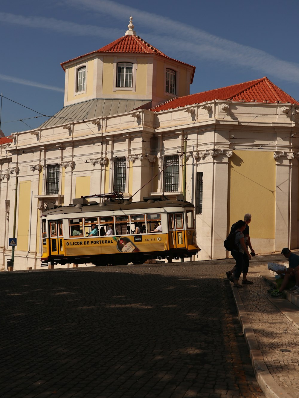 a yellow bus is parked in front of a building
