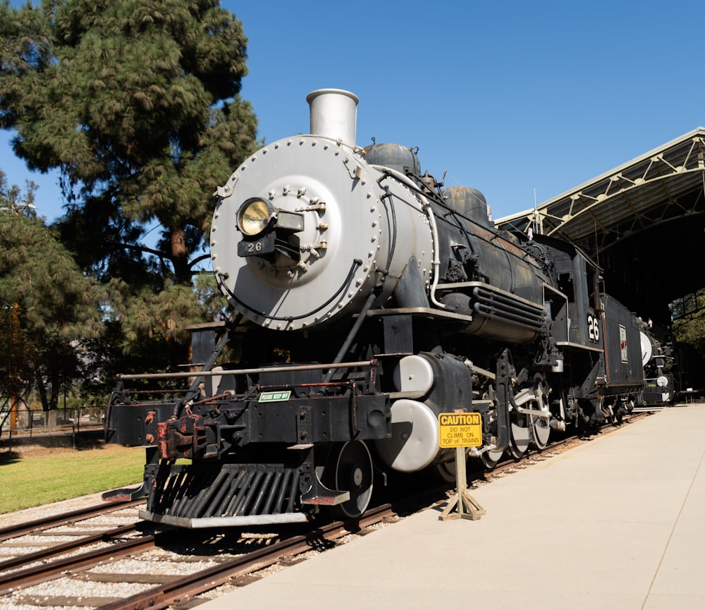 a black train engine sitting on the tracks