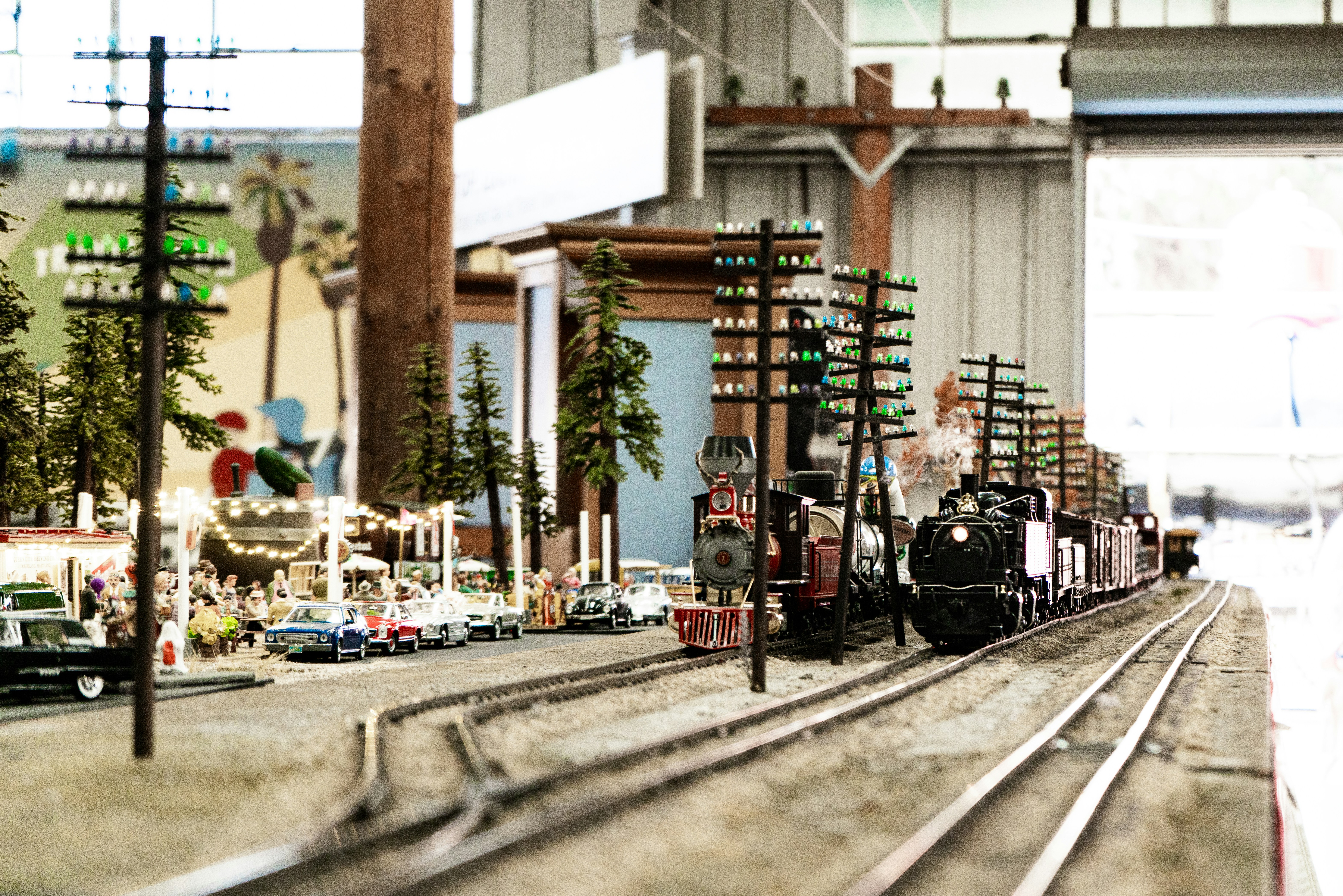 a model of a train station with cars on the tracks, 