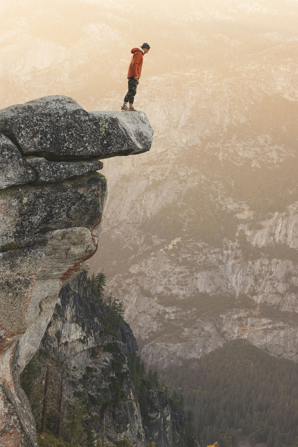 a man standing on top of a cliff