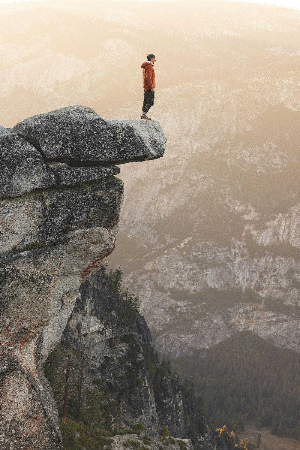 a man standing on top of a cliff