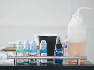a table topped with lots of bottles of liquid