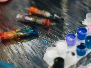 a close up of a table with many different colored bottles