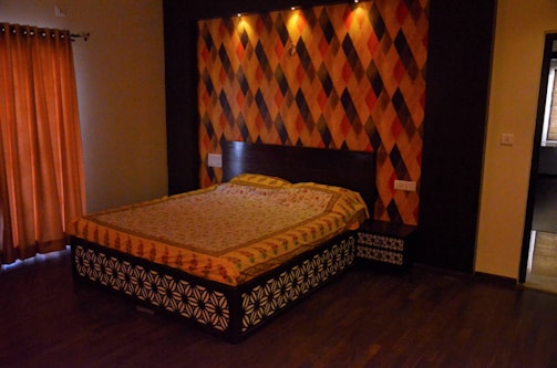 Spacious bedroom with colorful accents and comfortable bedding.