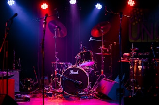 a desktop computer sitting on stage with stage lights and an audience