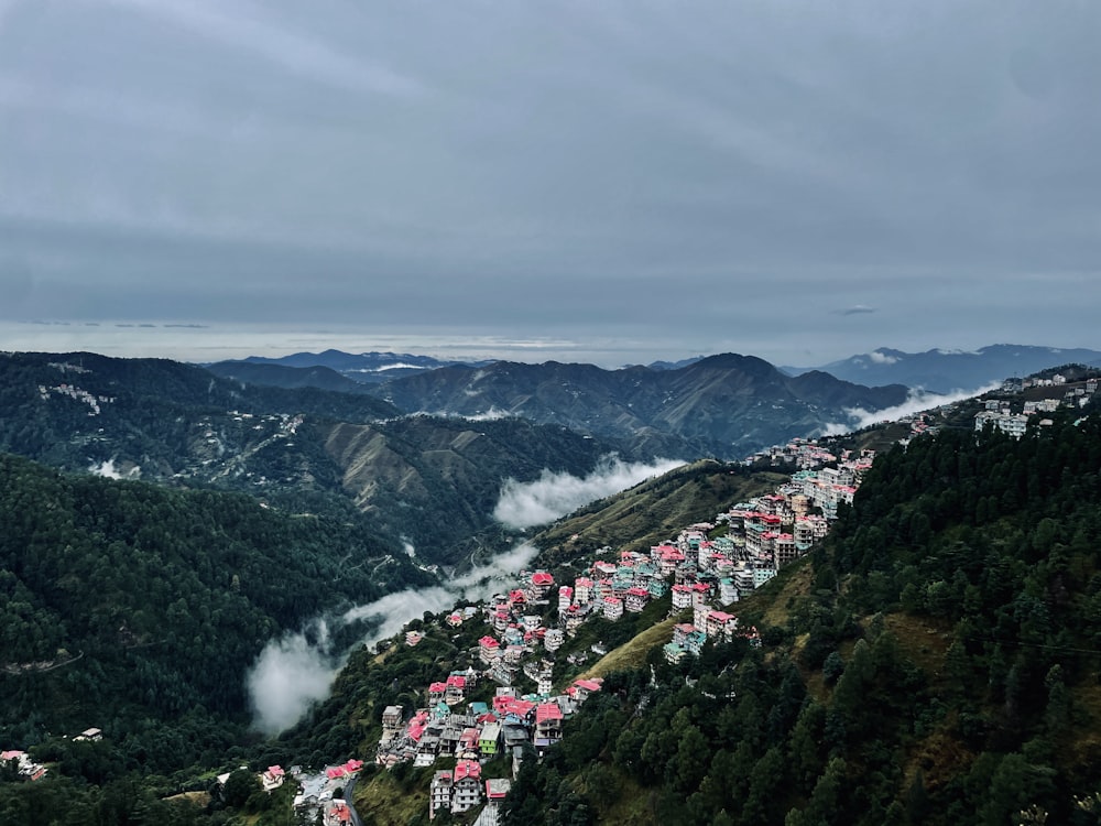 a view of a town in the middle of a mountain range