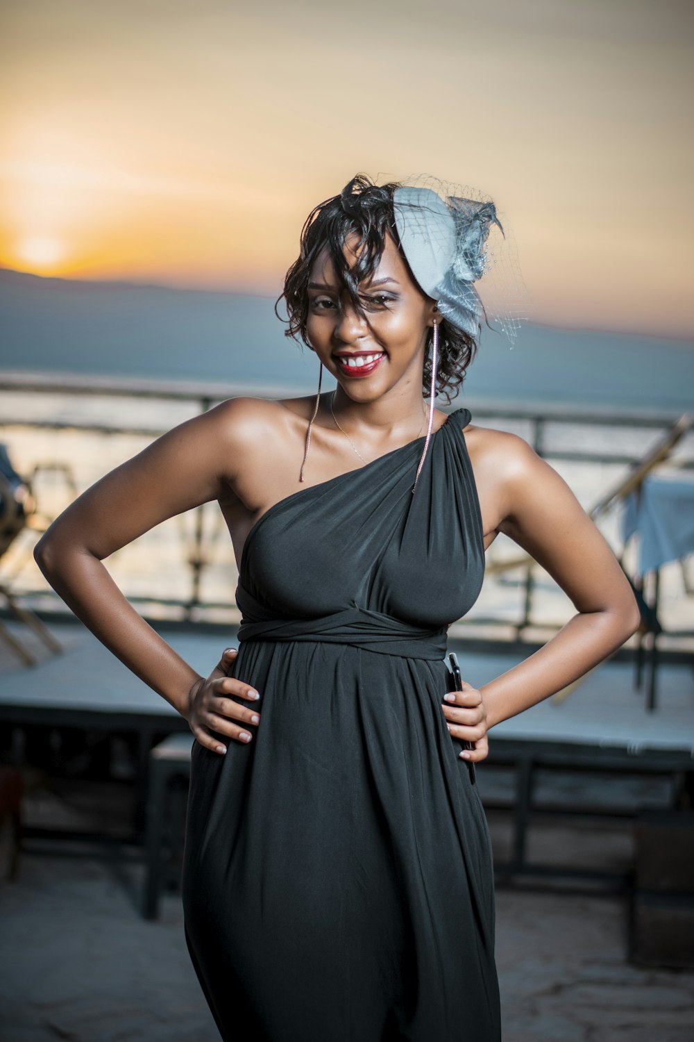 a woman in a black dress posing for a picture