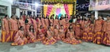A group of girls wearing colorful dresses at a celebration.
