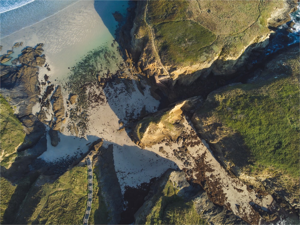 an aerial view of a sandy beach and ocean