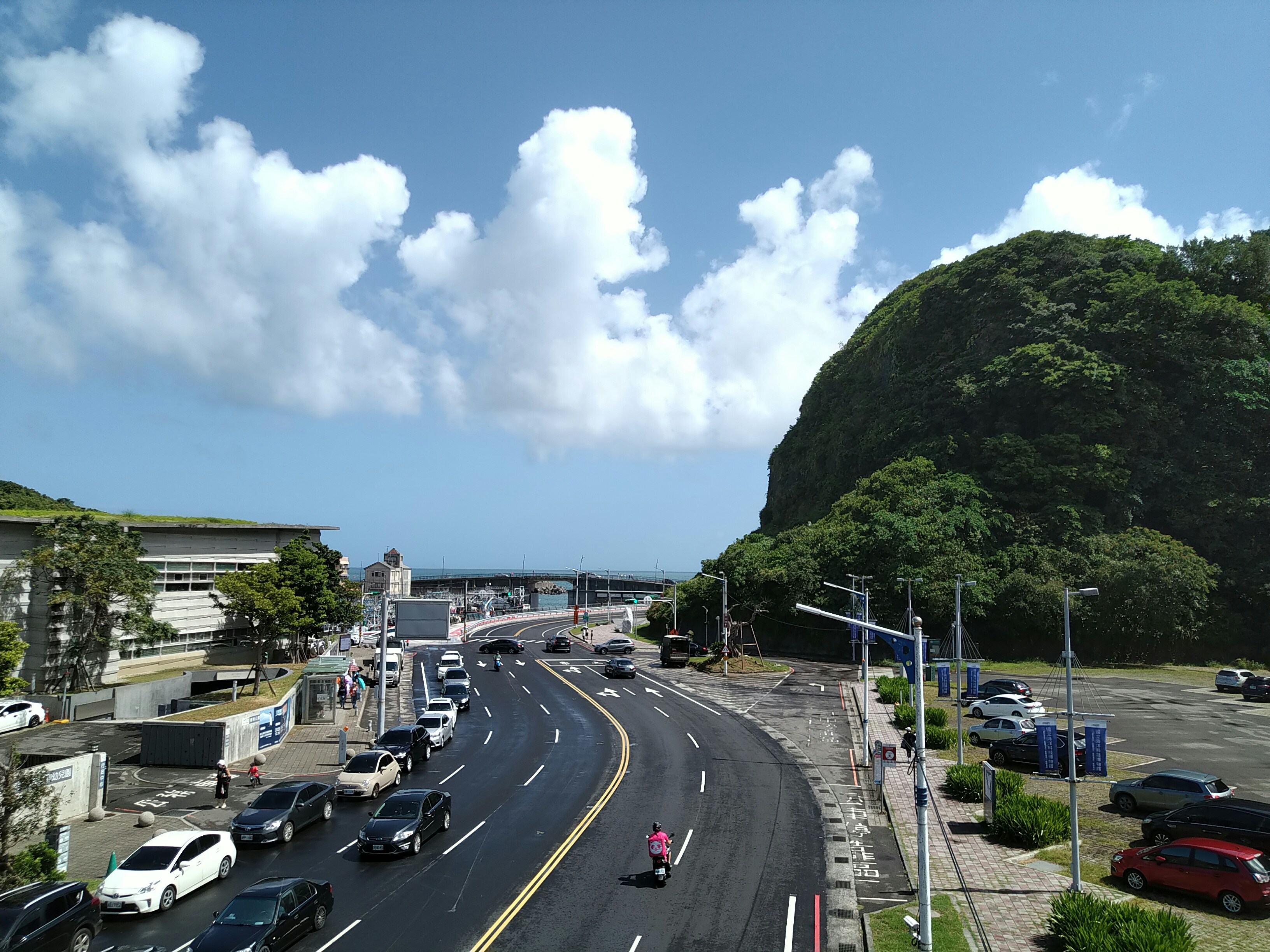 a city street with a mountain in the background