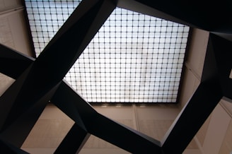 Close-up of a suspended ceiling grid being installed in a commercial space.