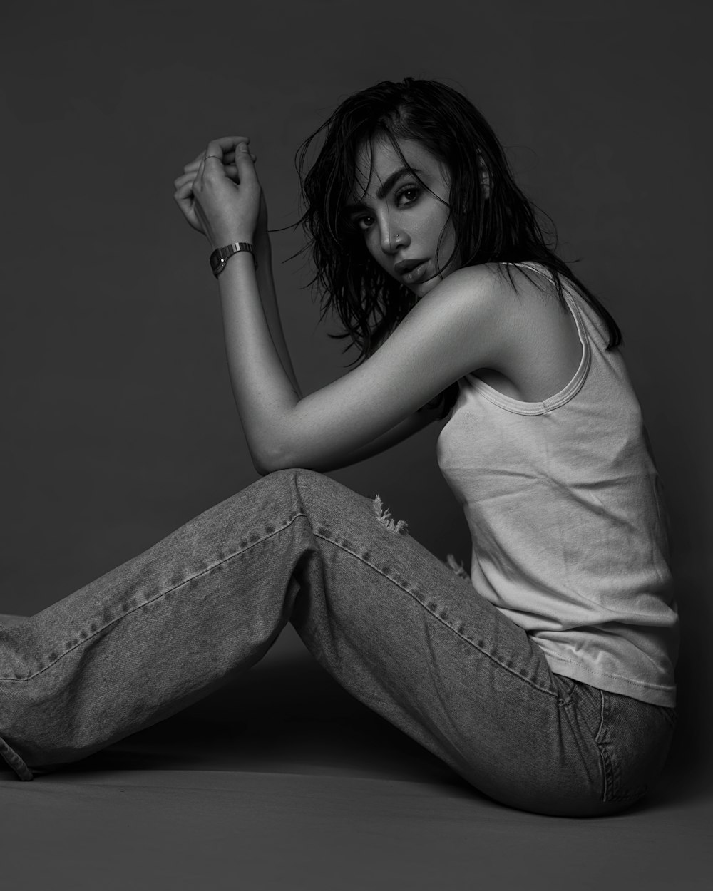 a woman is sitting on the floor posing for a picture