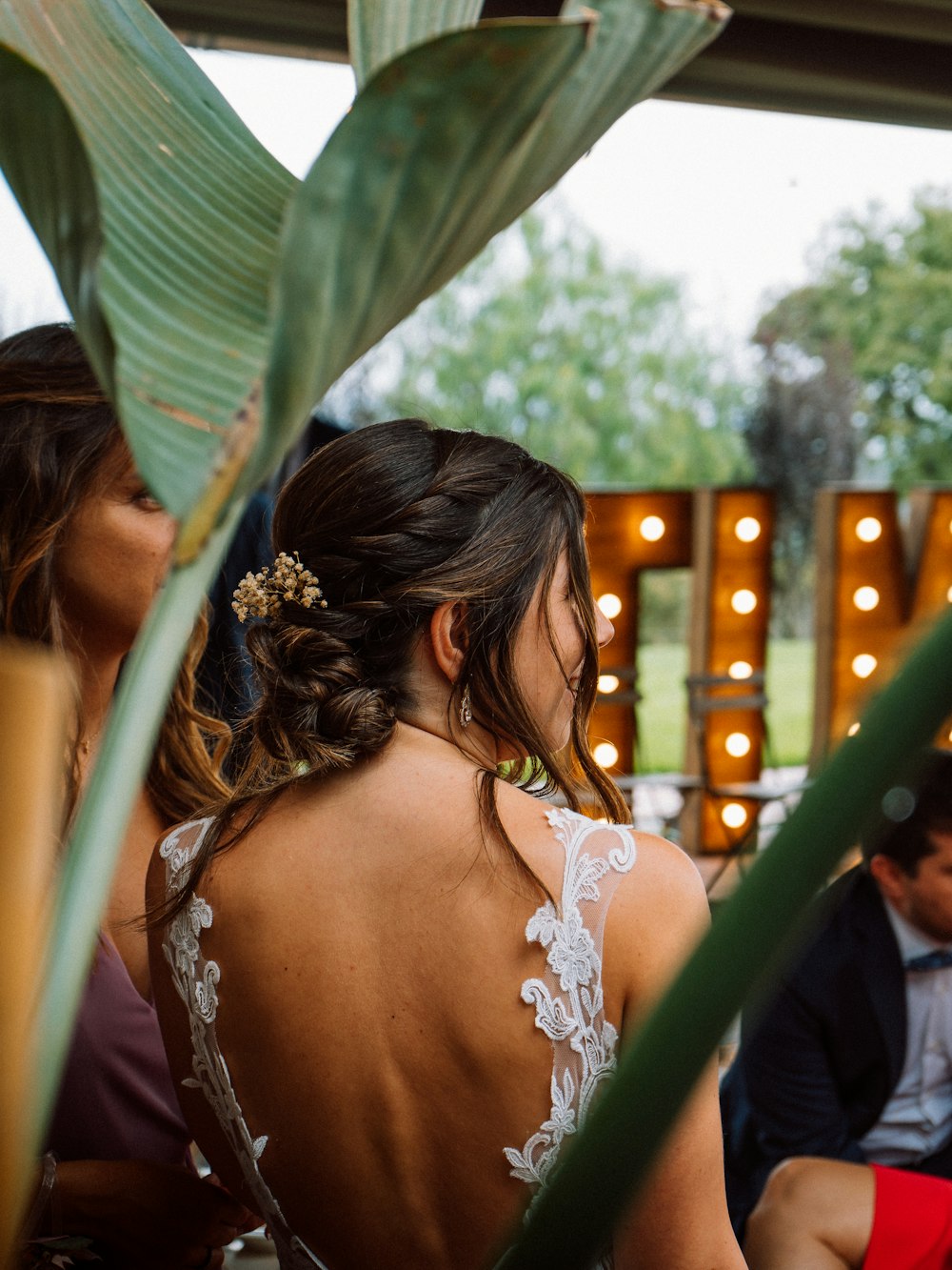 the back of a woman's dress as she sits at a table