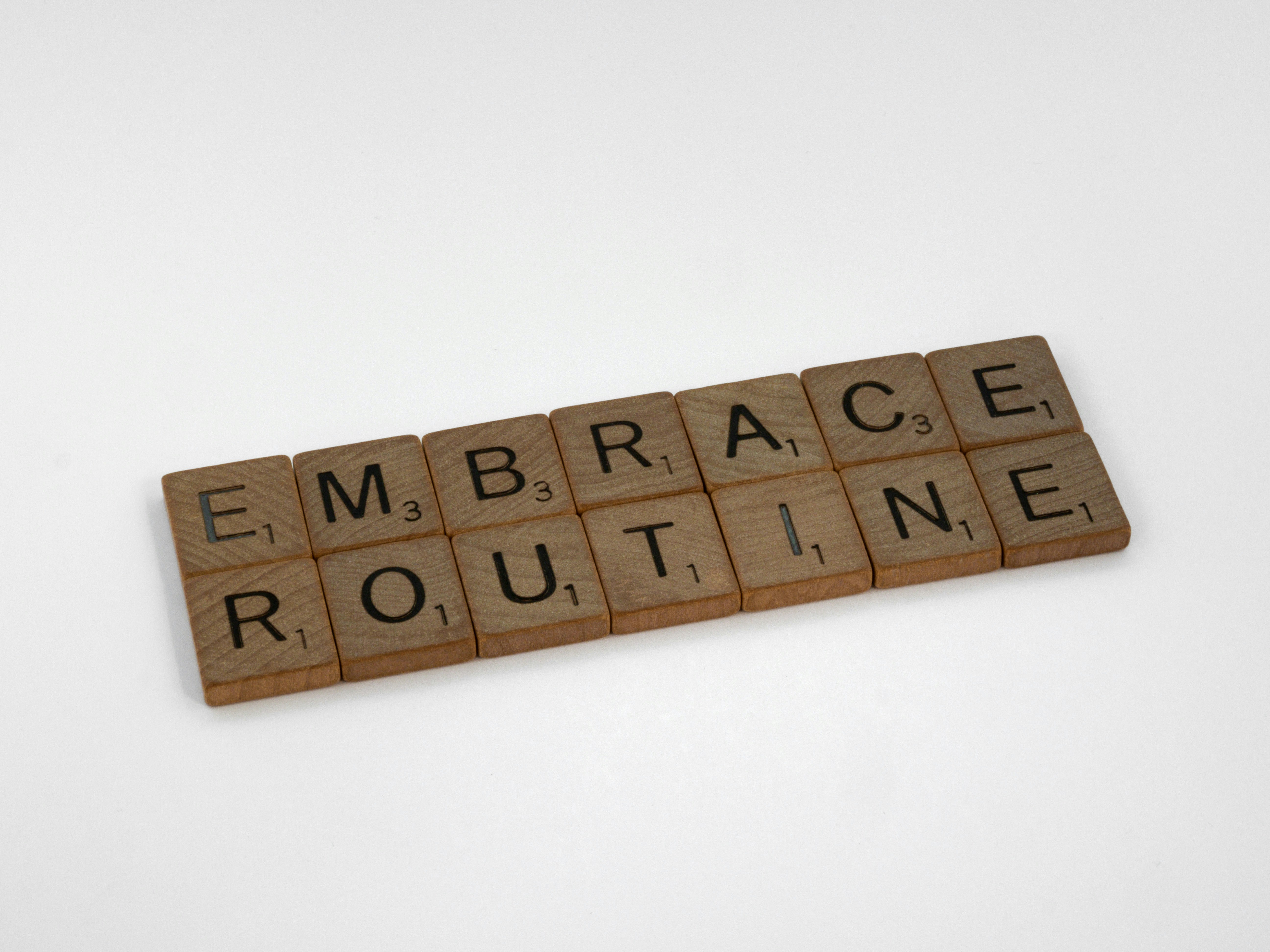 scrabble, scrabble pieces, lettering, letters, wood, scrabble tiles, white background, words, quote, letters, type, typography, design, layout, focus, bokeh, blur, photography, images, image, embrace routine, routine, regimen, discipline, grind, chores, ordinary, get things done, empty what is full, fill what is empty,  