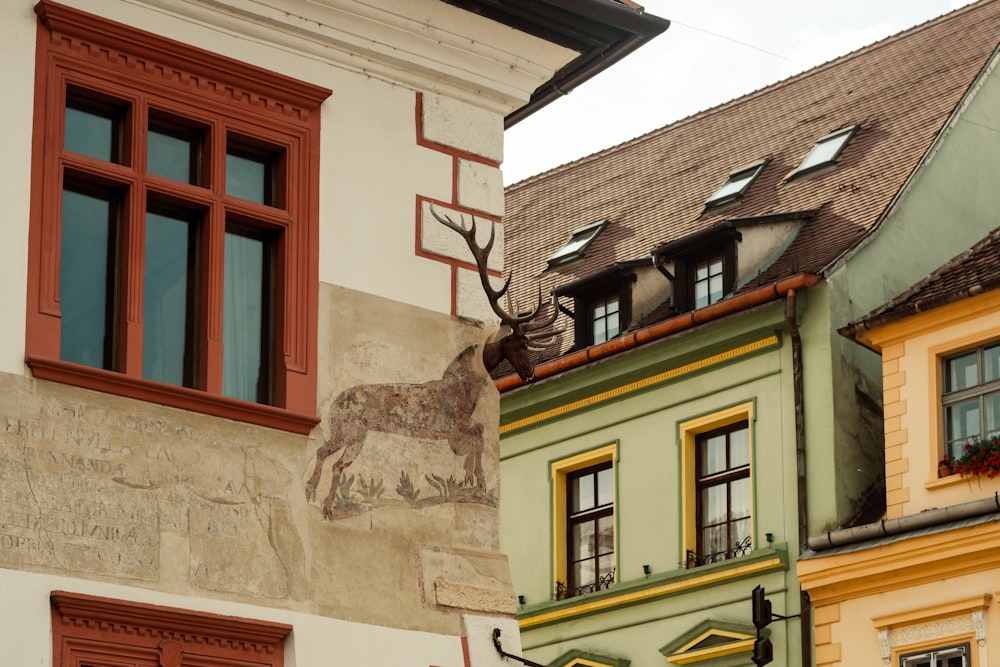 a building with a deer statue on the side of it