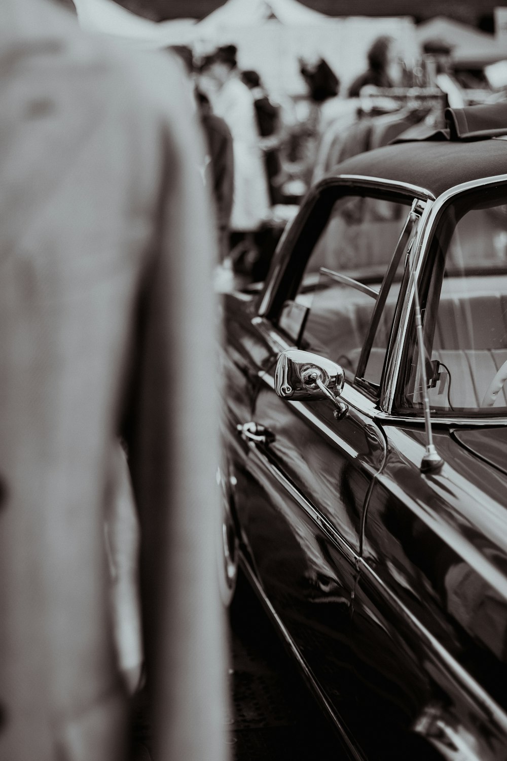 a black and white photo of a man in a car