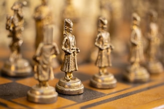 a close up of a chess board with figurines on it