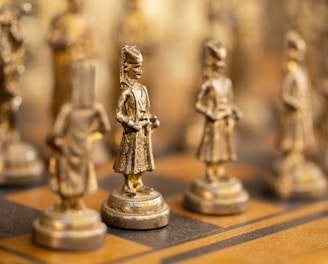 a close up of a chess board with figurines on it