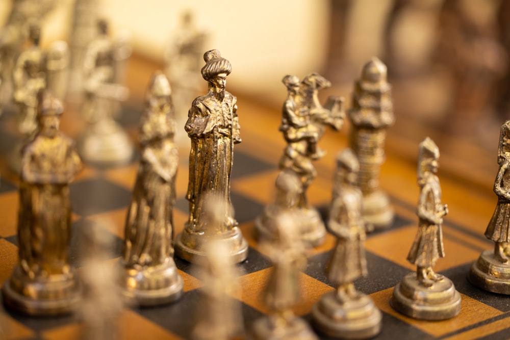 a close up of a chess board with figures on it