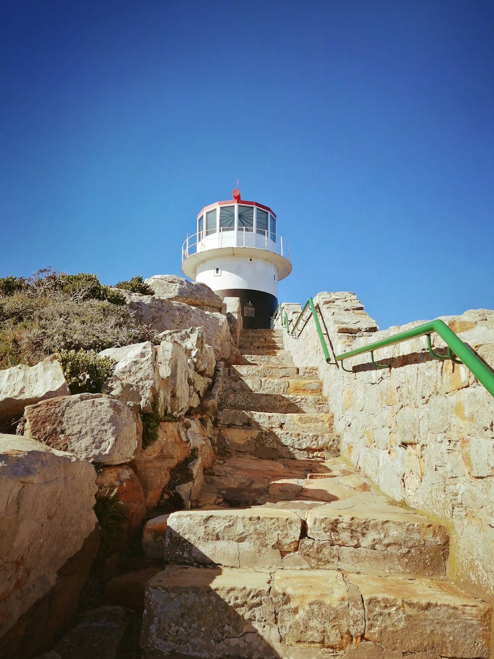 a lighthouse on top of a rocky cliff