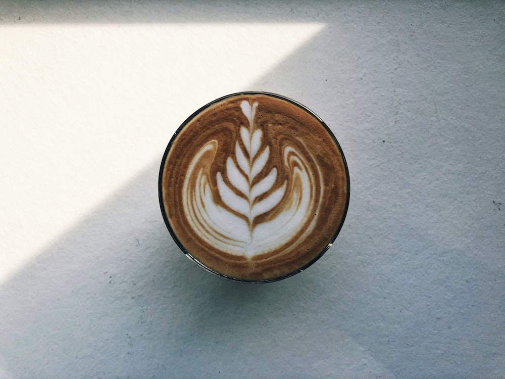 a cappuccino with a leaf drawn on it