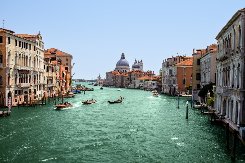 a view of a canal with gondolas in the distance