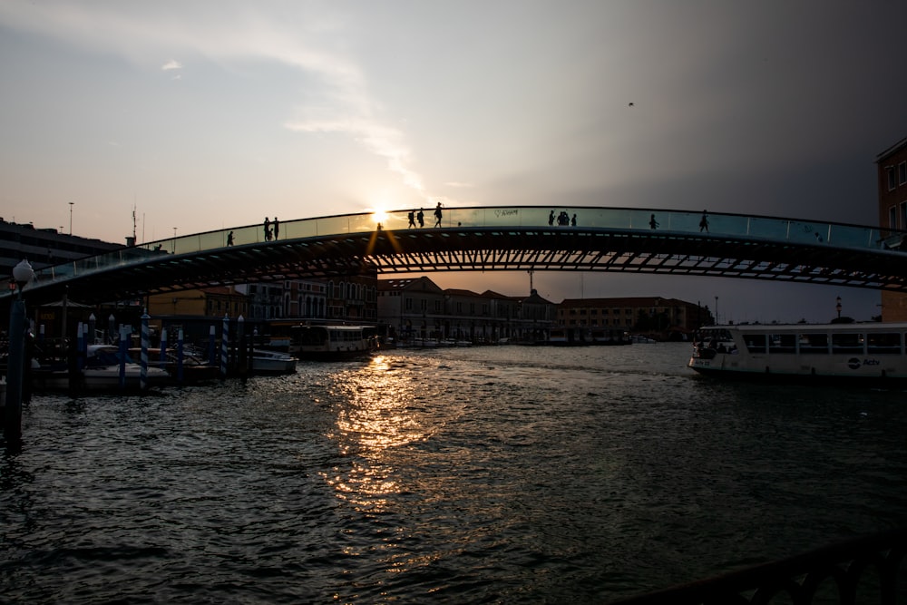 a bridge over a body of water at sunset