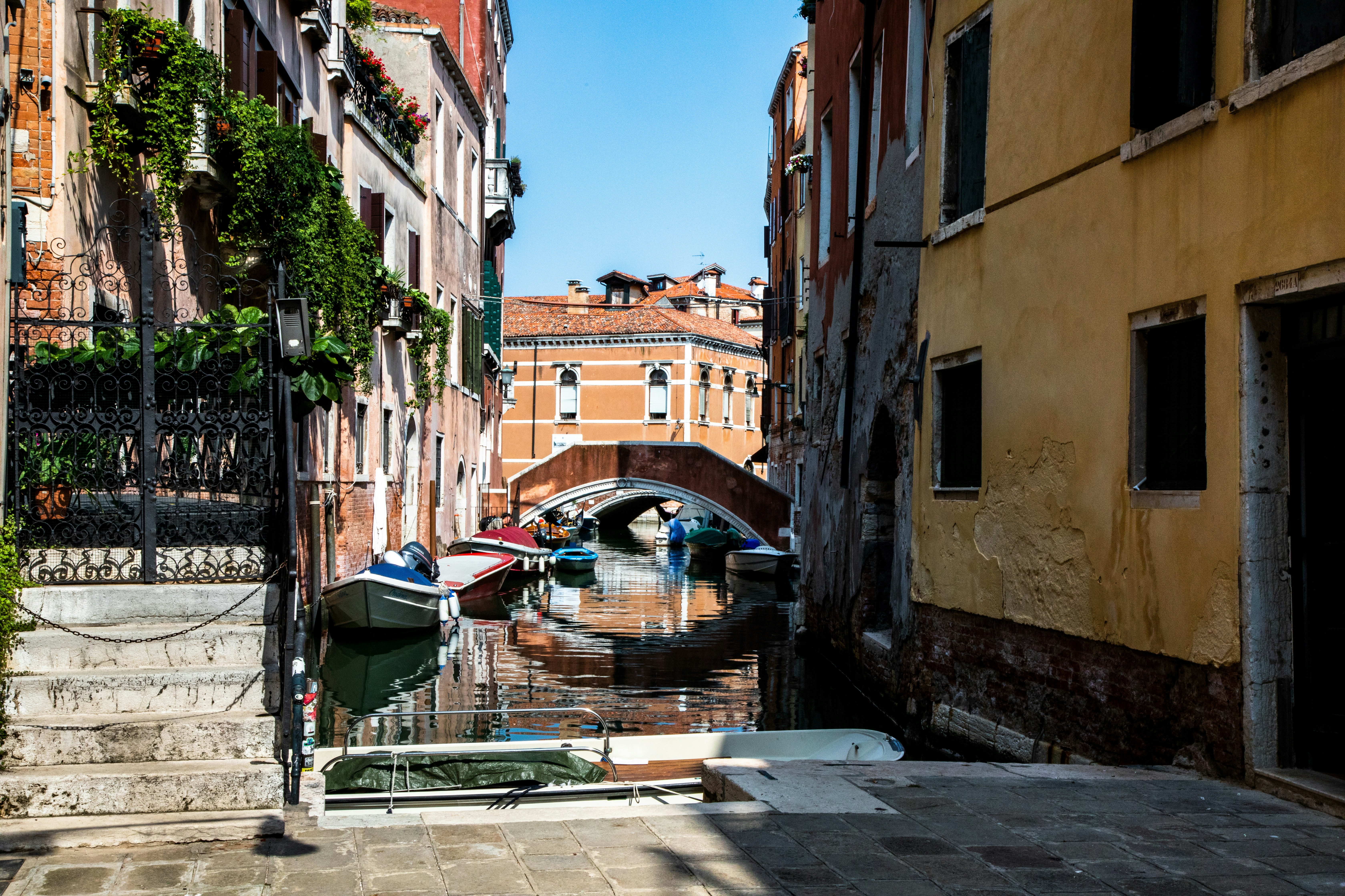 A narrow canal with a bridge in the background