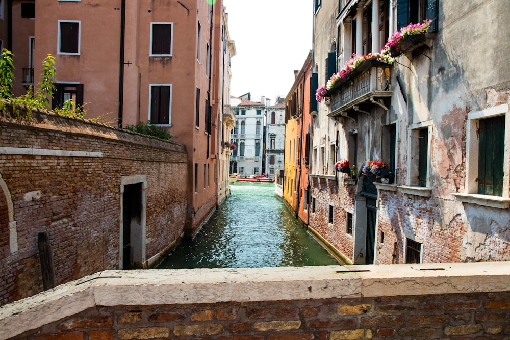 a narrow canal running between two buildings in venice